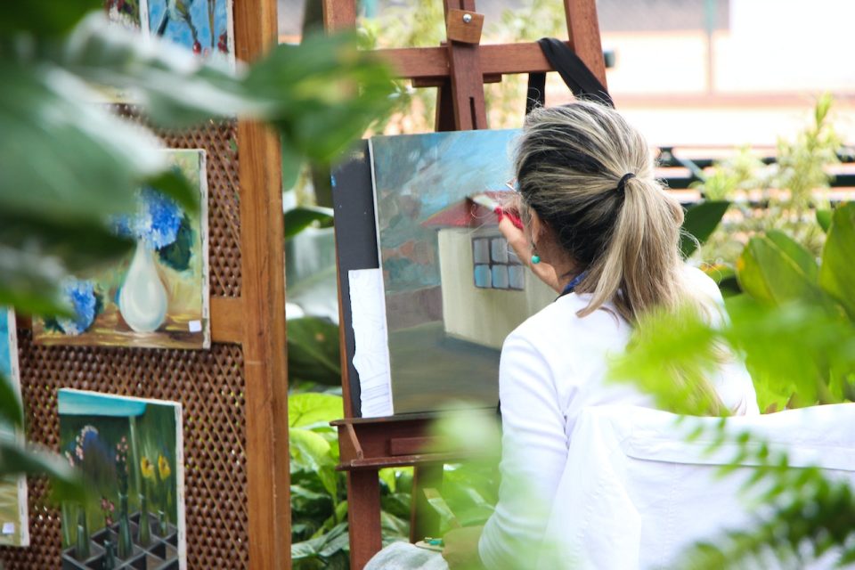 How can a painter effectively use brush strokes to create texture and depth in a painting?